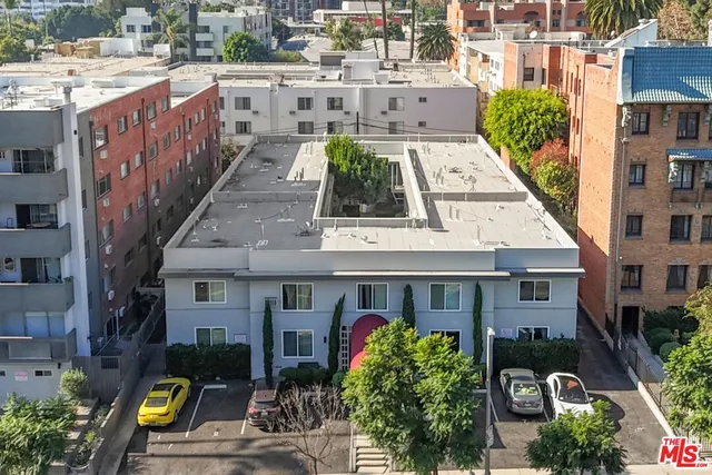 a view of a street with cars parked in front of it