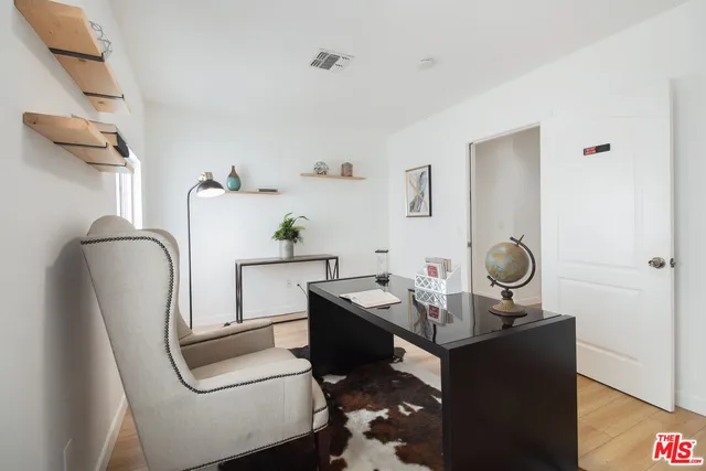 a room with a table chairs and wooden floor