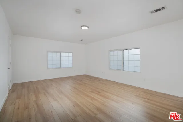 a bedroom with furniture and a flat screen tv
