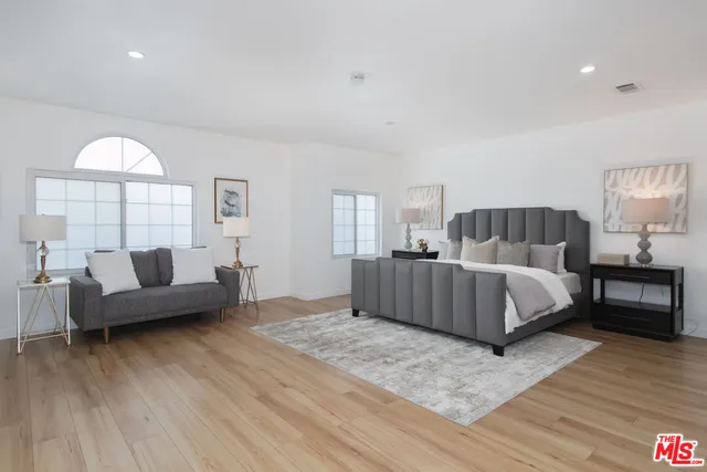 a bedroom with a large bed and a couch