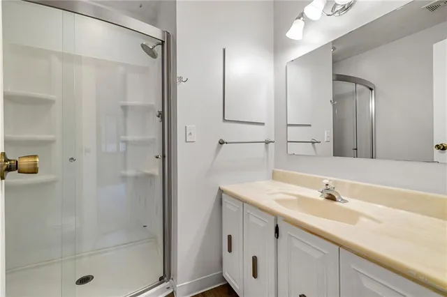 a bathroom with a shower sink and mirror