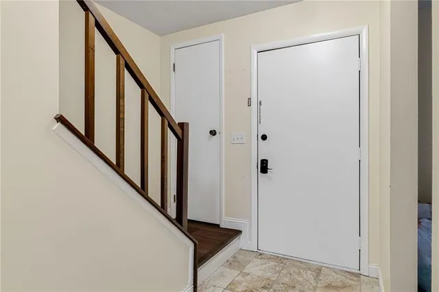 a view of a hallway with wooden floor and entryway