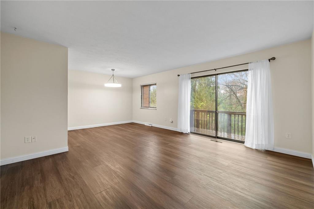 105 Springwater Court Coraopolis, PA 15108 - Photo 4 of 31 a view of an empty room with wooden floor and a window