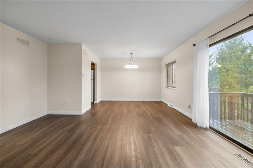 105 Springwater Court Coraopolis, PA 15108 - Photo 5 of 31 a view of an empty room with wooden floor and a window
