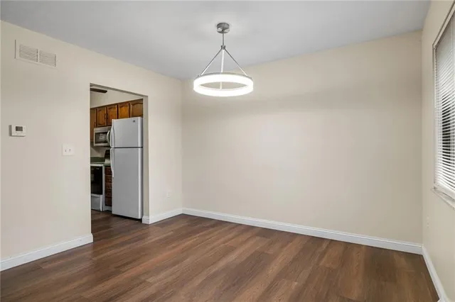a view of a room with wooden floor and white walls