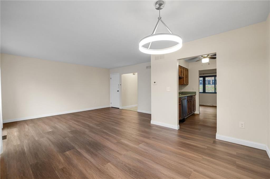105 Springwater Court Coraopolis, PA 15108 - Photo 7 of 31 a view of a room with wooden floor a ceiling fan and window