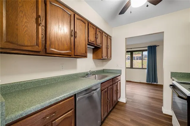 a kitchen with stainless steel appliances granite countertop a sink stove and cabinets
