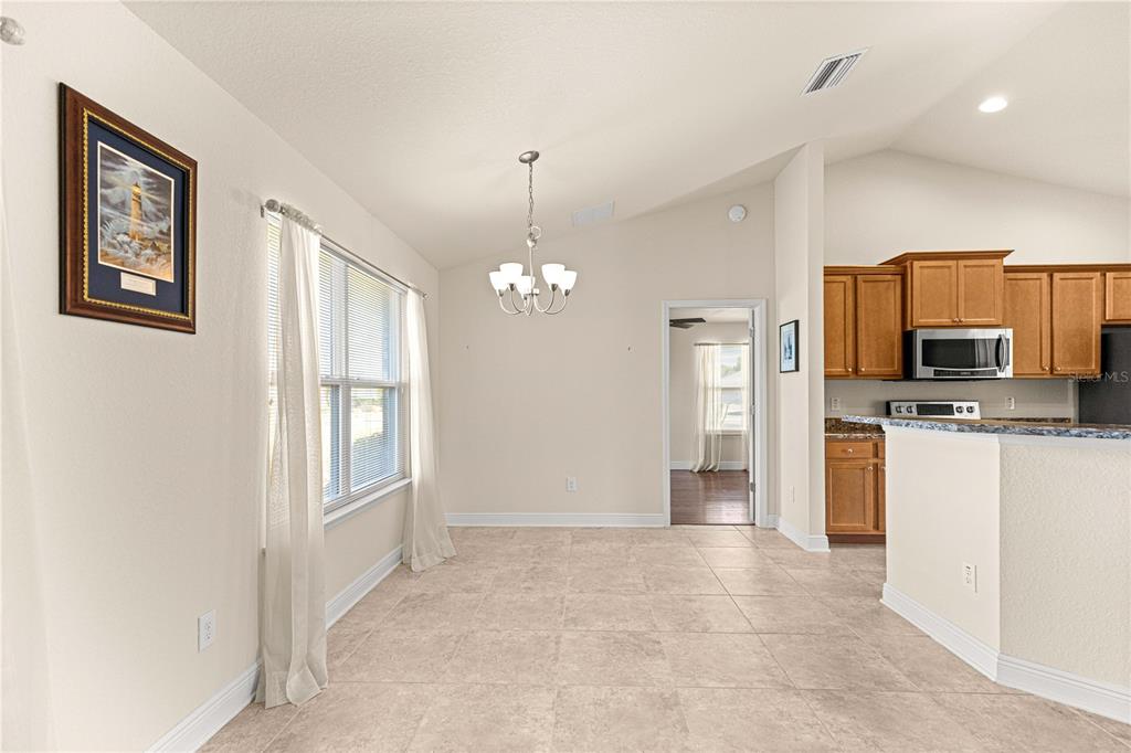 4401 Southwest 62nd Loop Ocala, FL 34474 - Photo 14 of 53 a view of a kitchen with a sink cabinet and a refrigerator