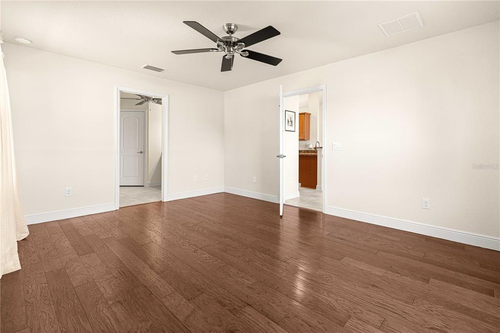 4401 Southwest 62nd Loop Ocala, FL 34474 - Photo 21 of 53 an empty room with wooden floor and windows
