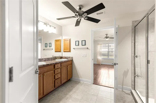 a bathroom with a glass shower door