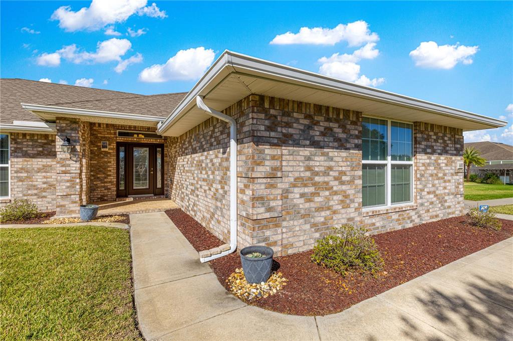 4401 Southwest 62nd Loop Ocala, FL 34474 - Photo 3 of 53 a front view of a house with a yard