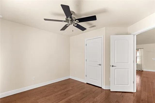 a view of a room with wooden floor and white walls