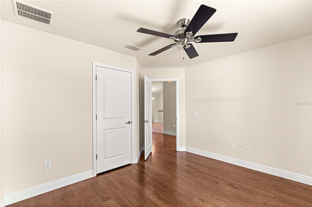 4401 Southwest 62nd Loop Ocala, FL 34474 - Photo 35 of 53 a view of a room with wooden floor and white walls