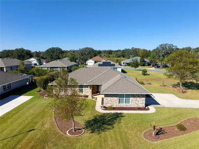 an aerial view of a house with a big yard