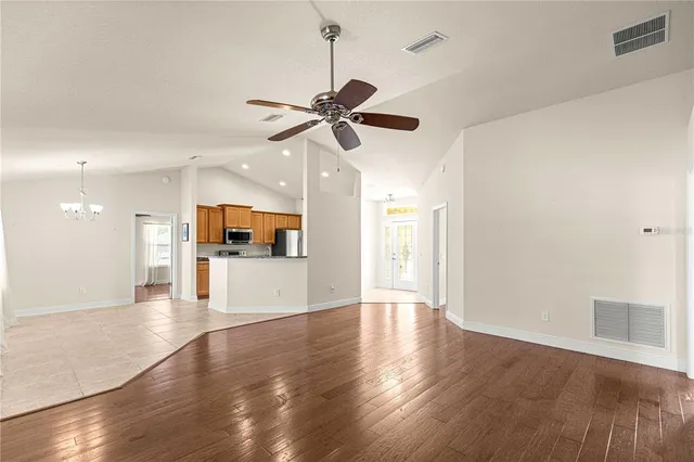 a view of a livingroom with a ceiling fan and wooden floor