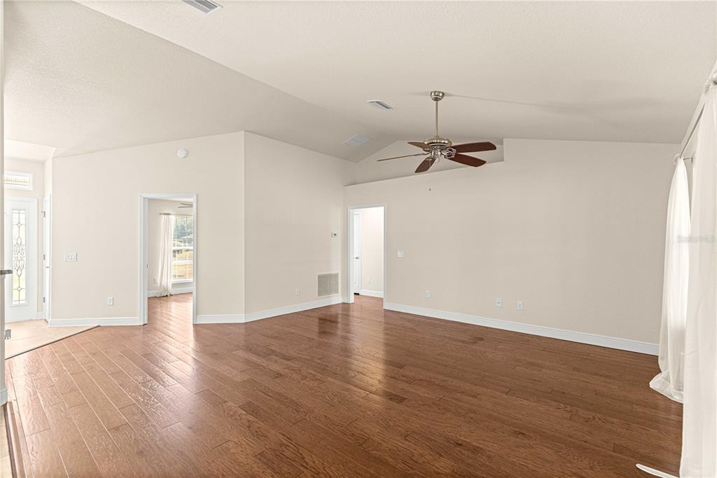 4401 Southwest 62nd Loop Ocala, FL 34474 - Photo 9 of 53 an empty room with a hardwood and ceiling fan