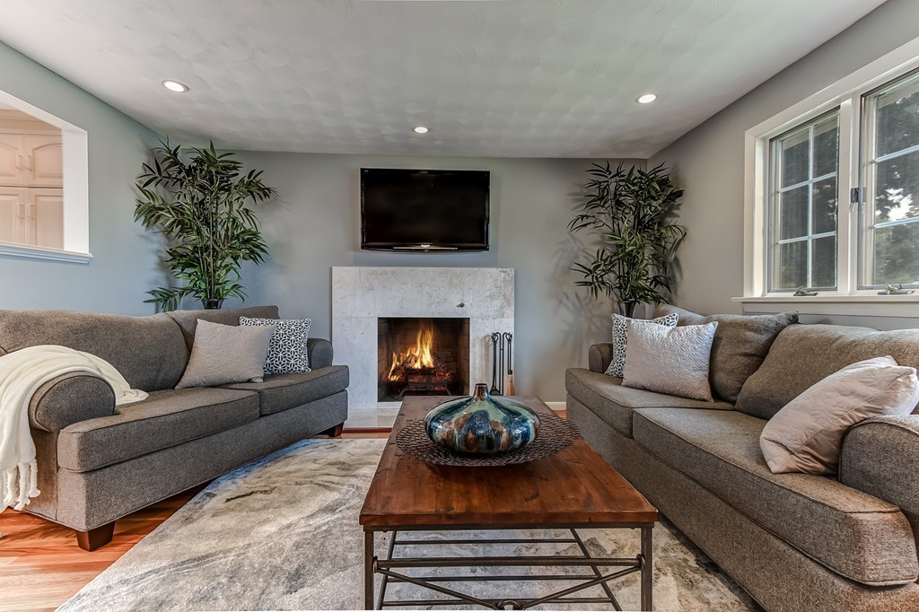 8 Jayne Road Needham, MA 02494 - Photo 5 of 24 a living room with furniture a flat screen tv and a fireplace