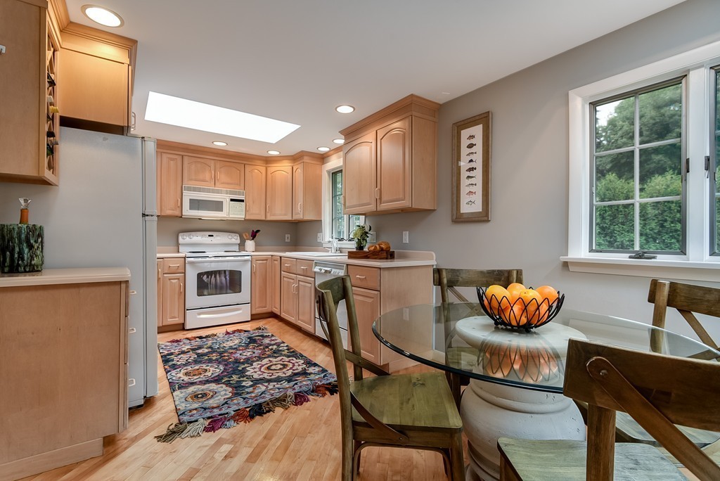8 Jayne Road Needham, MA 02494 - Photo 8 of 24 a kitchen with stainless steel appliances granite countertop a stove top oven a sink a dining table and chairs with wooden floor