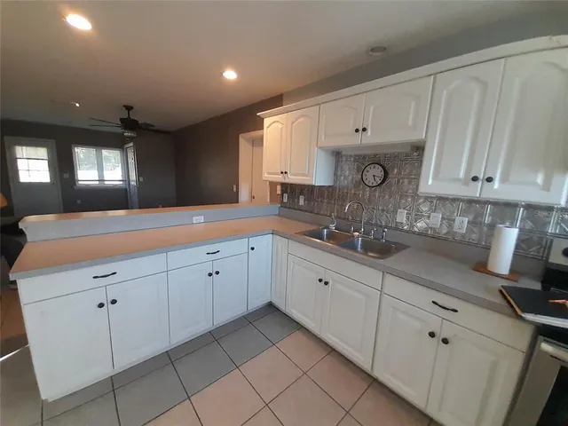 a backyard of a house with barbeque oven table and chairs