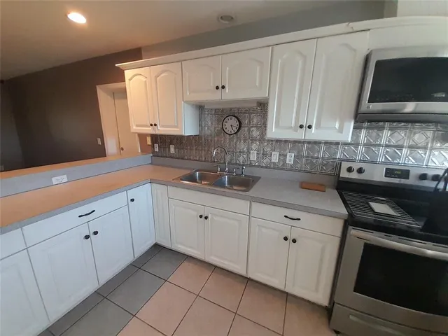 a view of a patio with a table chairs and a backyard