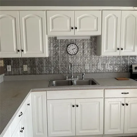 a view of a backyard with wooden fence