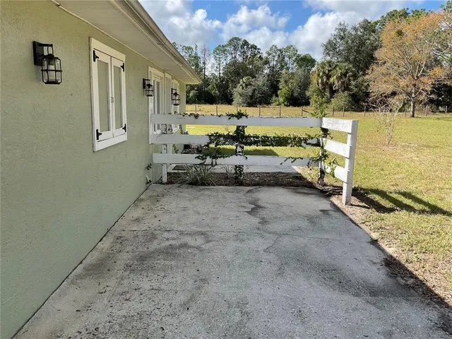 a view of balcony with wooden floor and fence