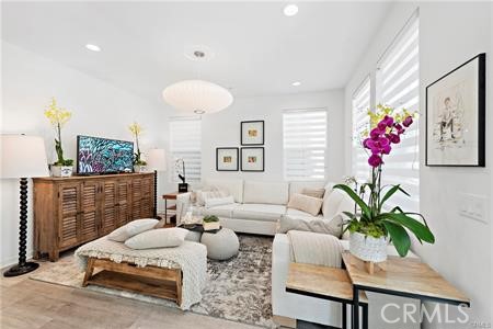 945 Sunlit Lane Costa Mesa, CA 92626 - Photo 14 of 31 a living room with furniture flowerpot and a chandelier