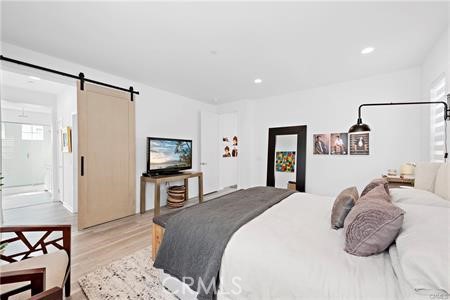 945 Sunlit Lane Costa Mesa, CA 92626 - Photo 19 of 31 a bedroom with a bed and a flat screen tv