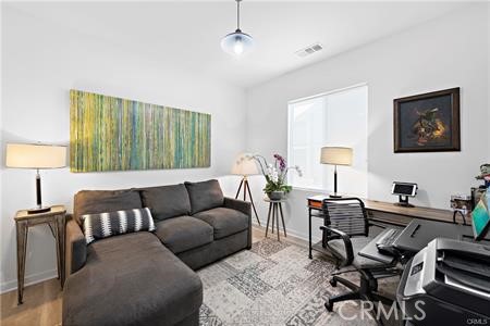 945 Sunlit Lane Costa Mesa, CA 92626 - Photo 23 of 31 a living room with furniture and a lamp