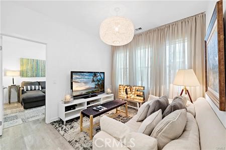 945 Sunlit Lane Costa Mesa, CA 92626 - Photo 24 of 31 a living room with furniture a window and a flat screen tv