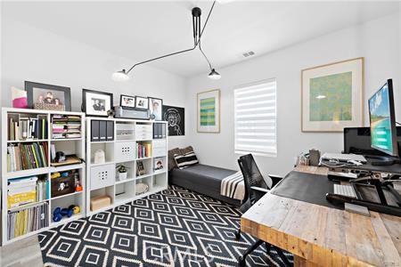 945 Sunlit Lane Costa Mesa, CA 92626 - Photo 25 of 31 a view of a workspace with furniture and a bookshelf