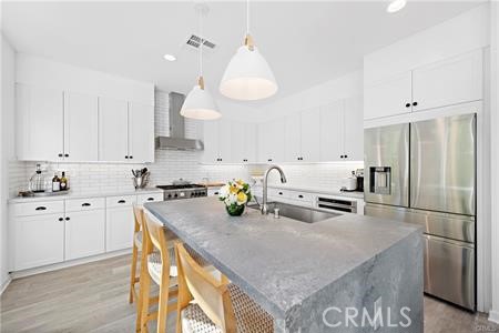 945 Sunlit Lane Costa Mesa, CA 92626 - Photo 4 of 31 a kitchen with stainless steel appliances granite countertop a sink a stove and a refrigerator