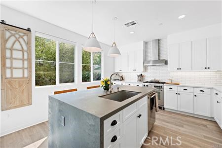 945 Sunlit Lane Costa Mesa, CA 92626 - Photo 5 of 31 a kitchen with a sink stove and cabinets
