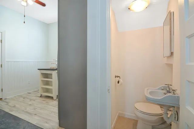 a bathroom with a granite countertop toilet and a sink