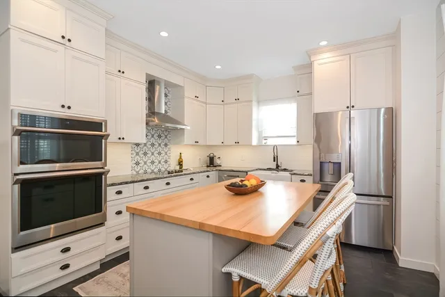 a kitchen with a appliances a stove a microwave and cabinets