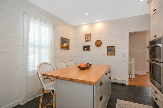 a kitchen that has a sink a stove and a refrigerator