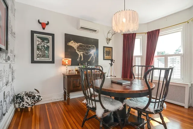 a view of a dining room with furniture window and wooden floor
