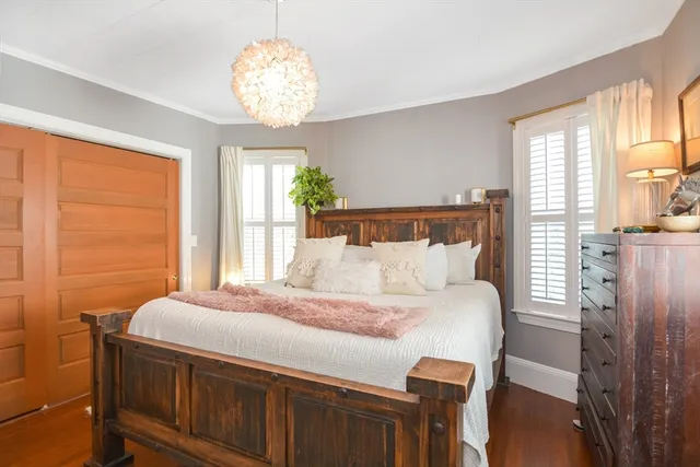 a bedroom with a bed and a chandelier