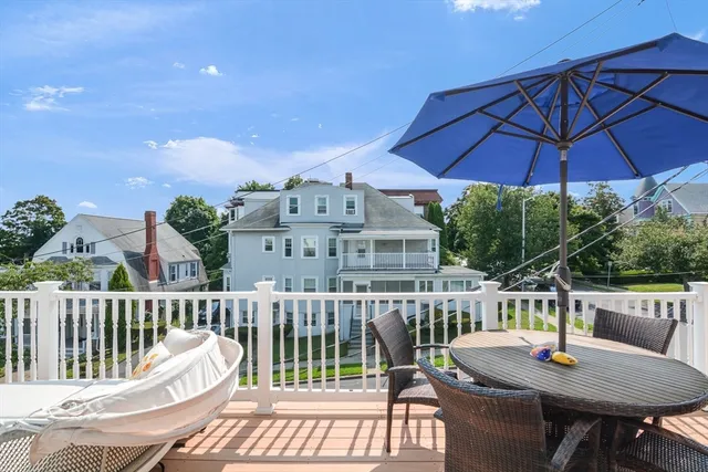 a view of a chair and table on the deck