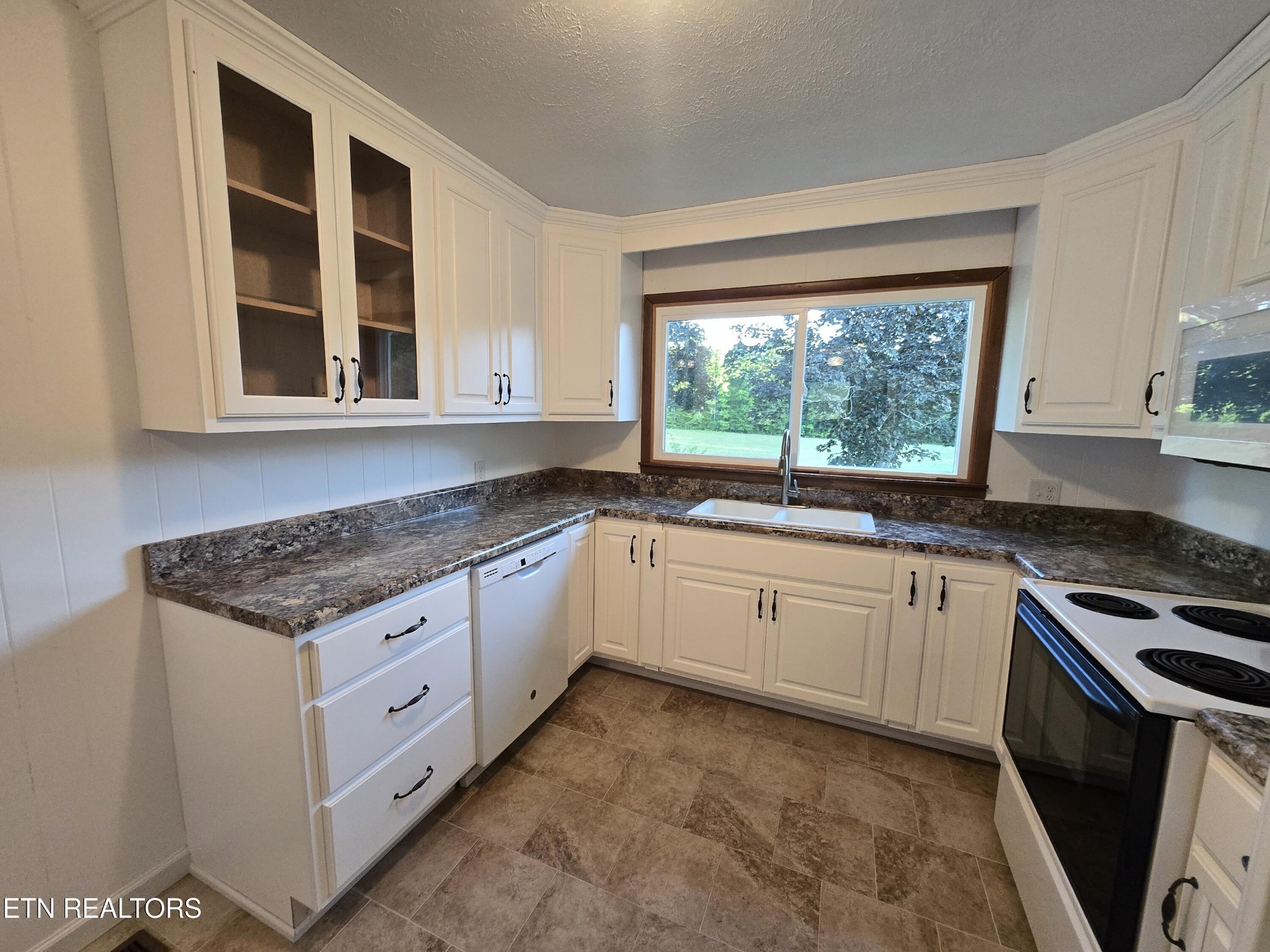 295 Bilbrey Road Crossville, TN 38571 - Photo 11 of 32 a kitchen with stainless steel appliances granite countertop a stove a sink and a microwave