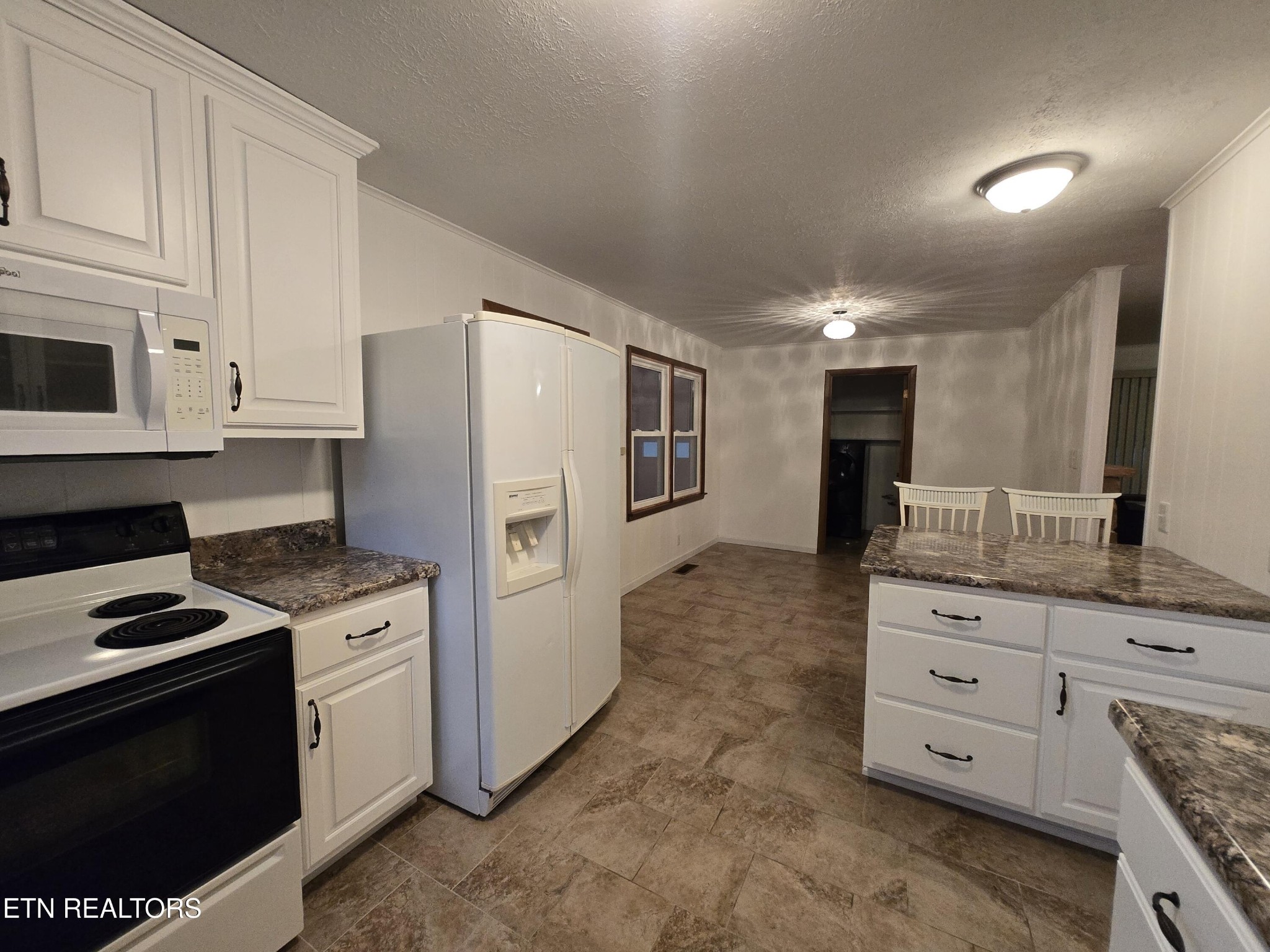295 Bilbrey Road Crossville, TN 38571 - Photo 13 of 32 a kitchen with cabinets and stainless steel appliances