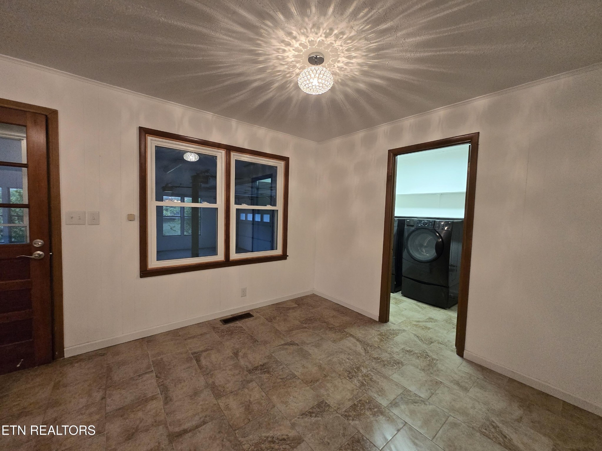 295 Bilbrey Road Crossville, TN 38571 - Photo 14 of 32 an empty room with chandelier fan and windows