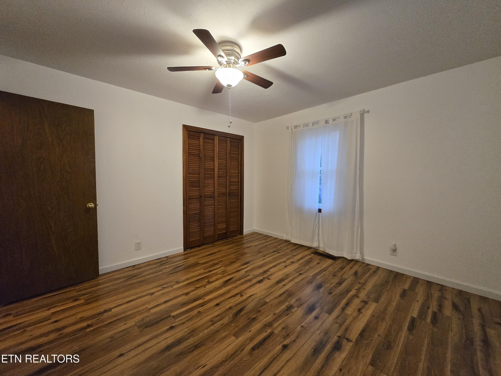 295 Bilbrey Road Crossville, TN 38571 - Photo 20 of 32 a view of an empty room with wooden floor
