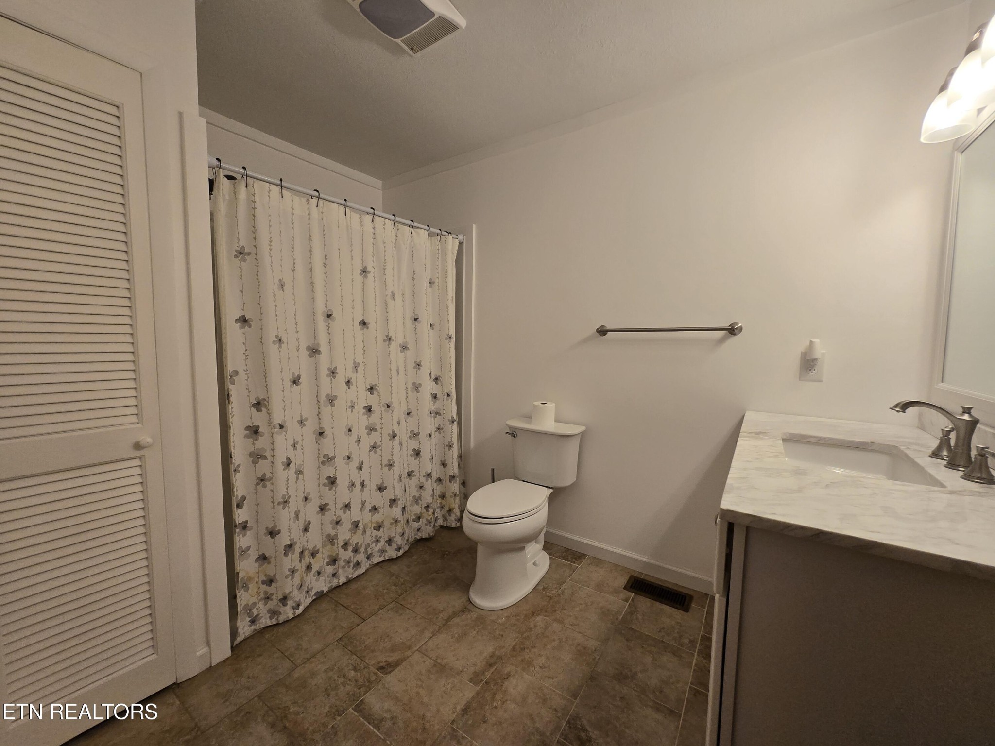 295 Bilbrey Road Crossville, TN 38571 - Photo 22 of 32 a bathroom with a granite countertop sink toilet and shower