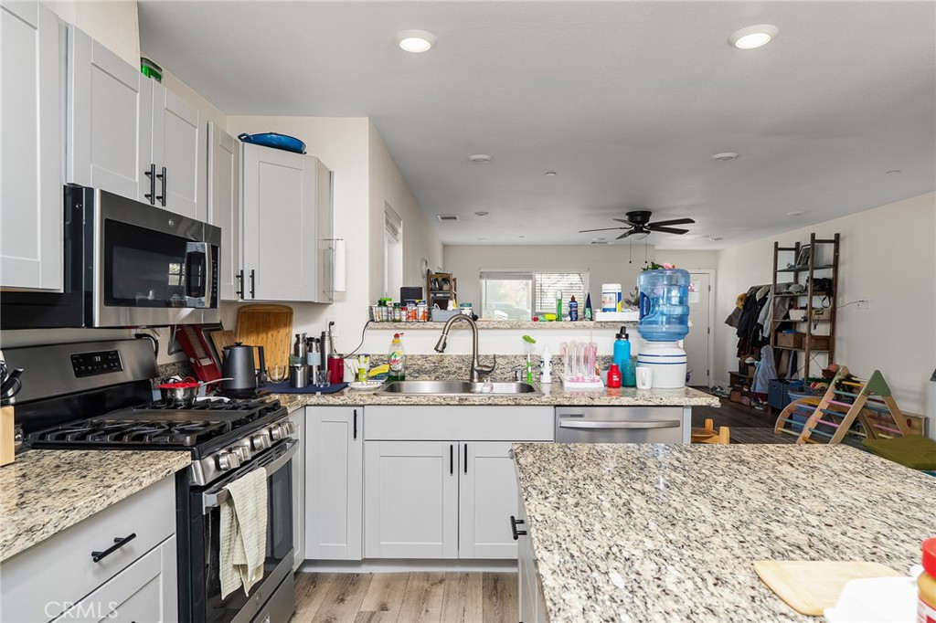 6033 Pentz Road Paradise, CA 95969 - Photo 18 of 54 a kitchen with stainless steel appliances granite countertop a sink stove and white cabinets