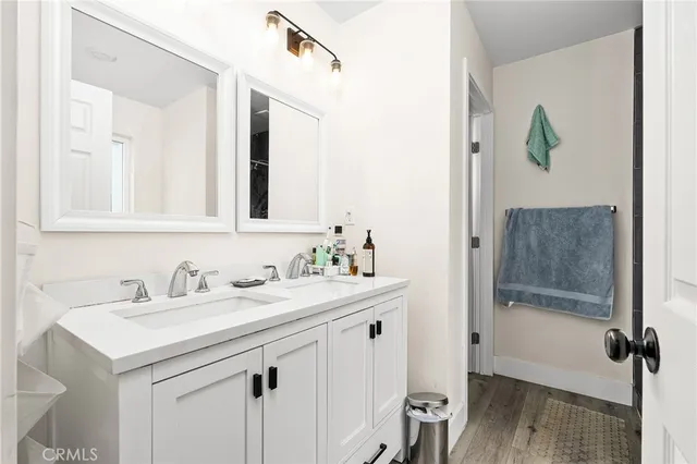 a bathroom with a sink vanity and tub