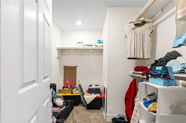 a spacious bedroom with a bed and a ceiling fan