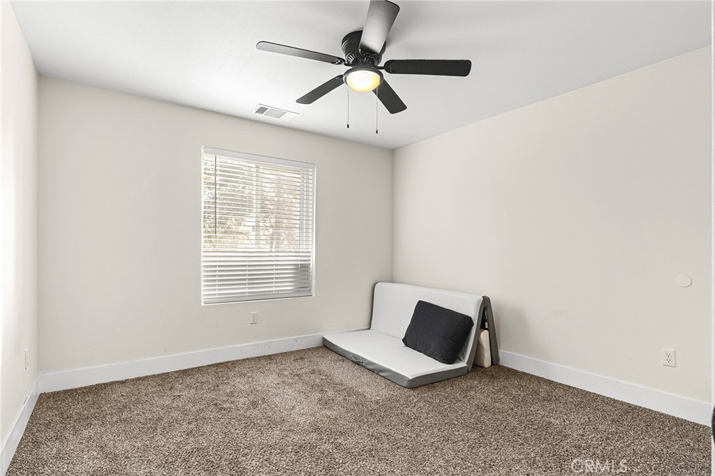 6033 Pentz Road Paradise, CA 95969 - Photo 33 of 54 a spacious bedroom with a bed and a ceiling fan