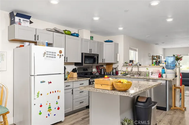 a kitchen with refrigerator and sink