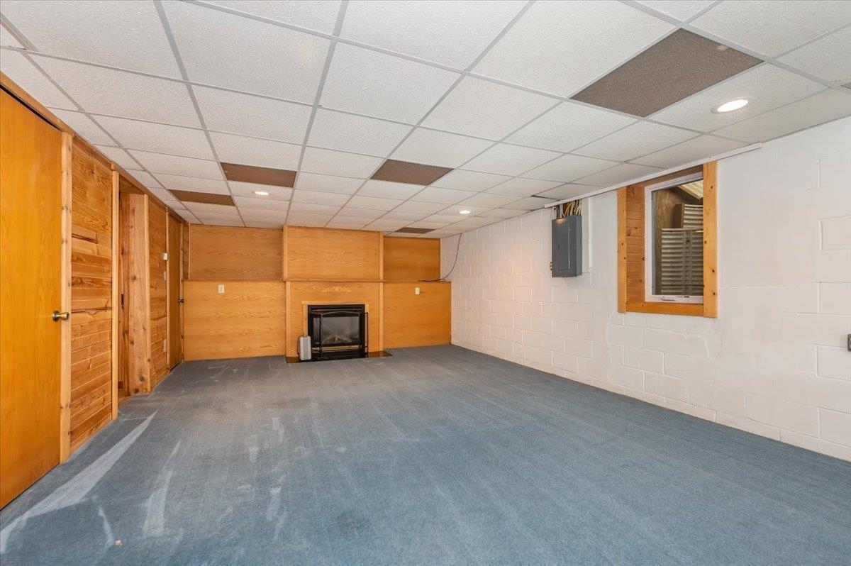404 Alcohol Road Wrenshall, MN 55797 - Photo 19 of 32 Finished below grade area with a drop ceiling, recessed lighting, carpet floors, electric panel, and a fireplace